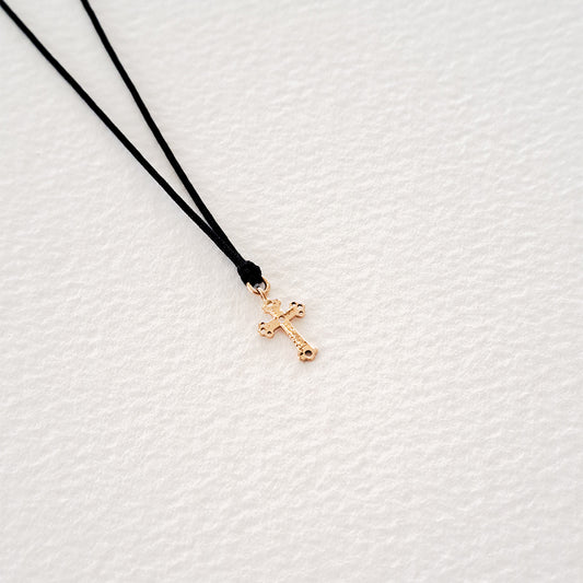 Cross pendant on thread