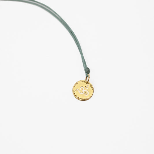 Om pendant on thread