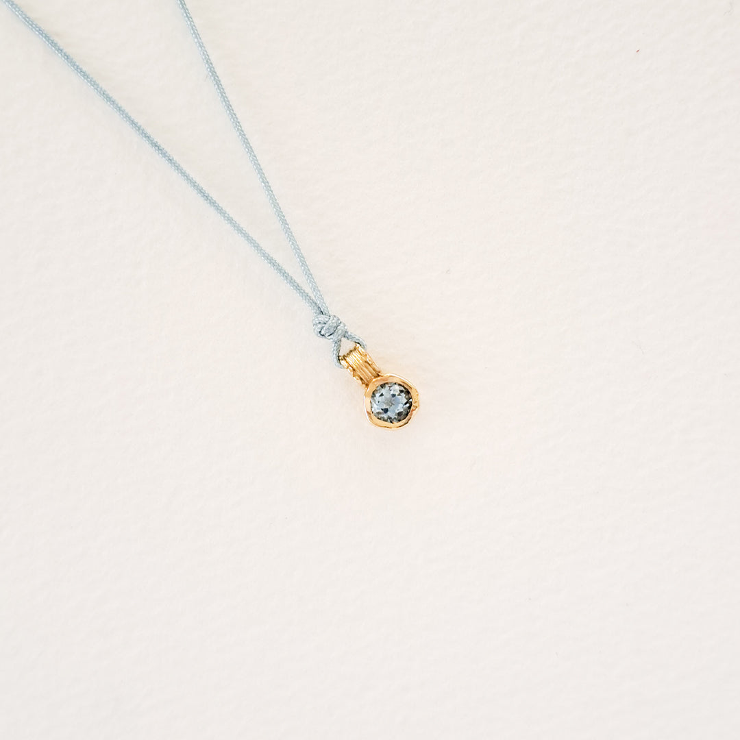 Water/Blue Topaz pendant on thread