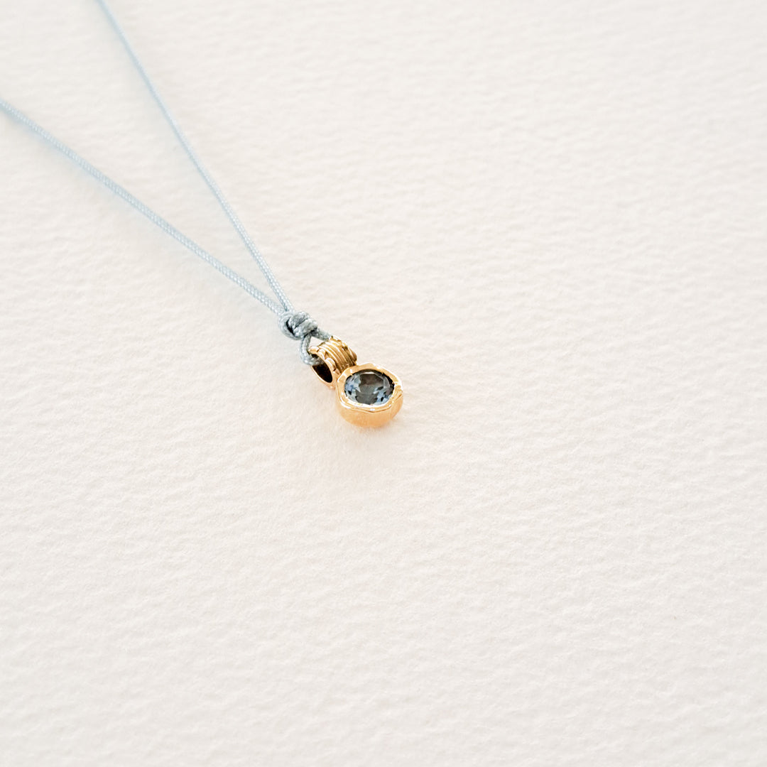 Water/Blue Topaz pendant on thread