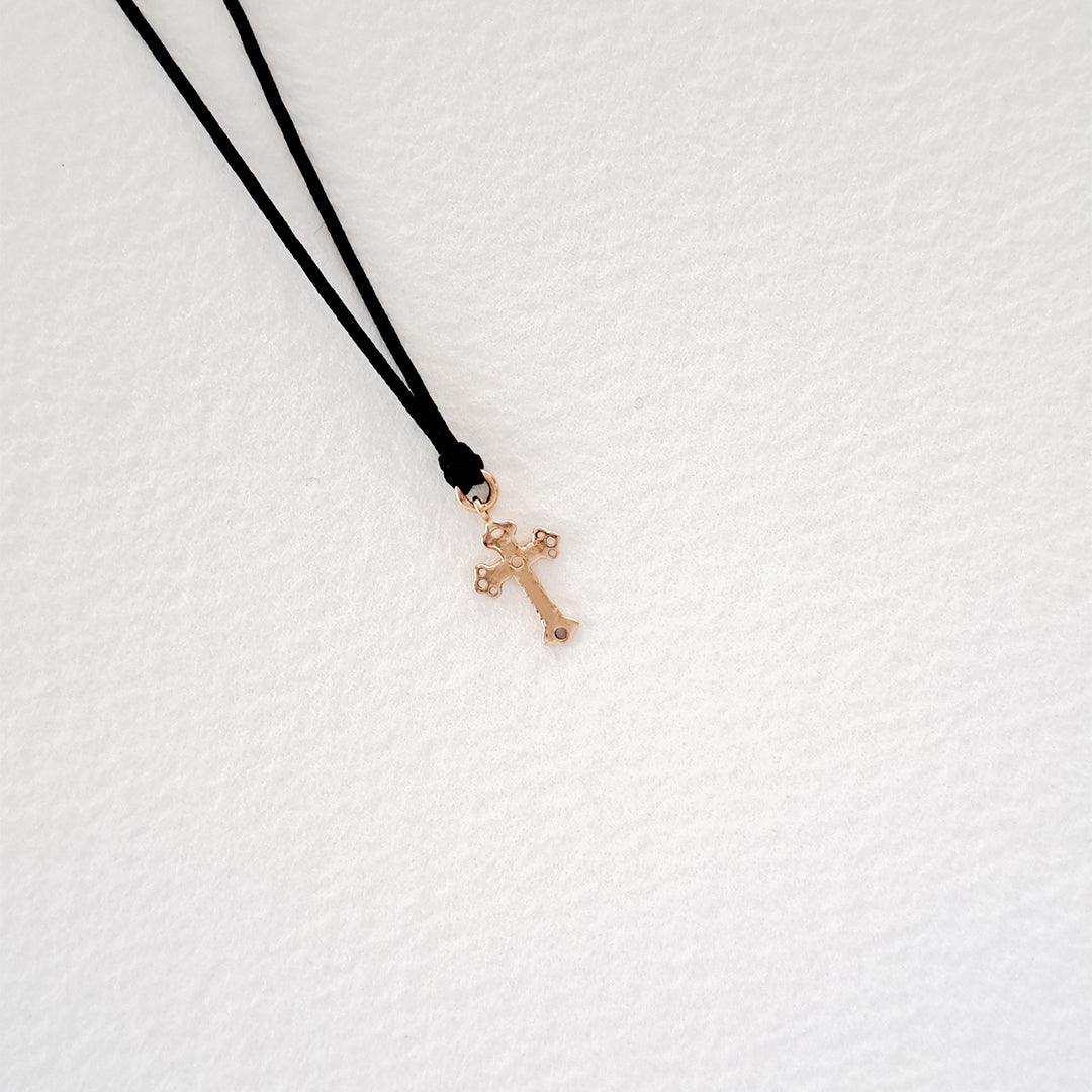 Cross pendant on thread
