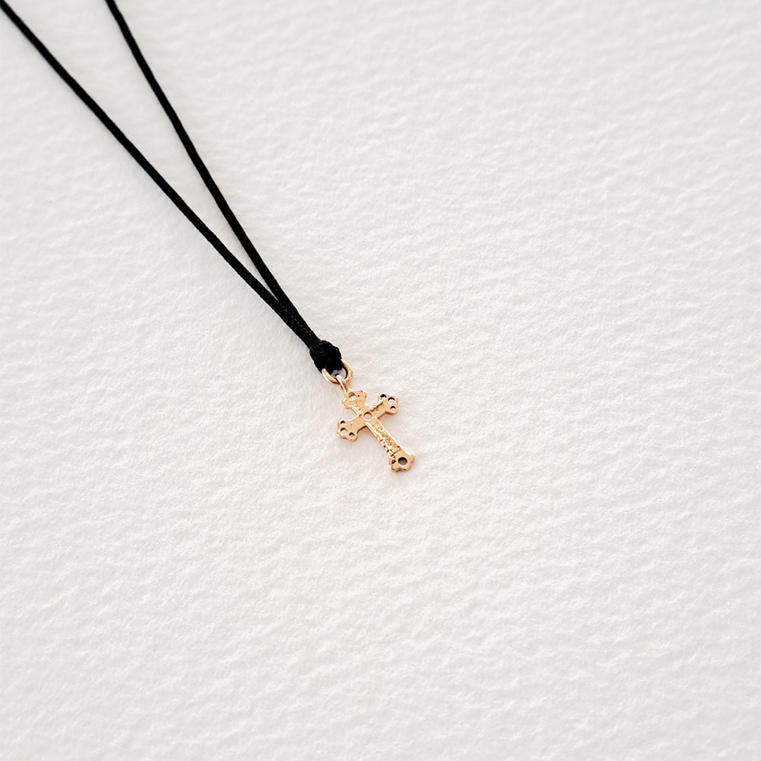 Cross pendant on thread