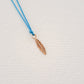 Feather pendant on thread