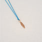 Feather pendant on thread