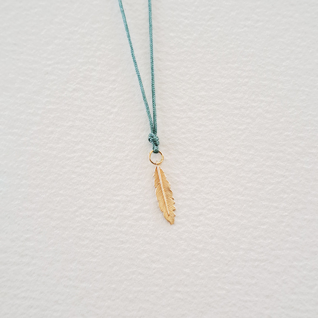 Feather pendant on thread