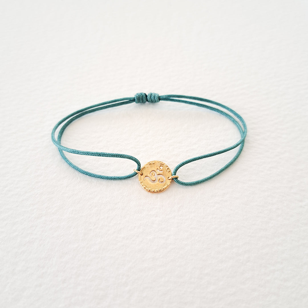 Om bracelet on thread