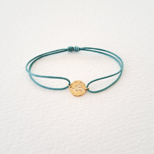 Om bracelet on thread